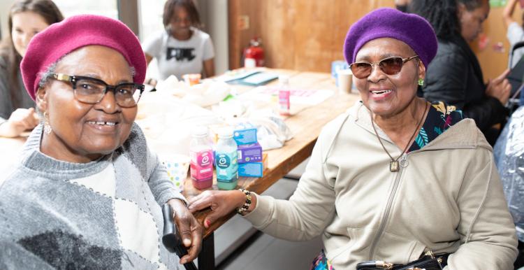 Two older women smiling at the camera