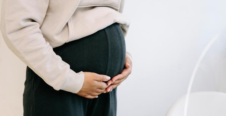 pregnant woman holding her stomach