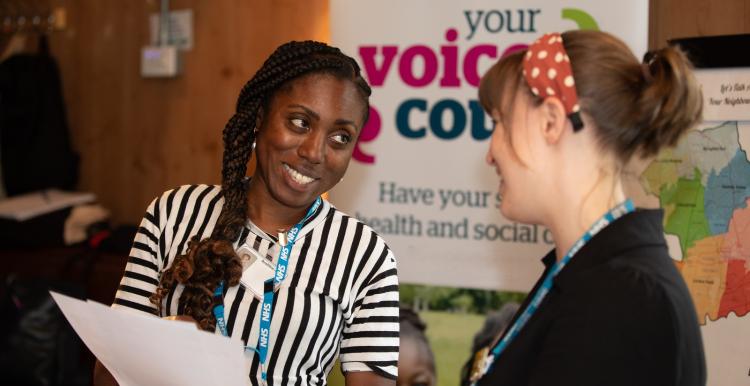 Two women sharing insights at conference.