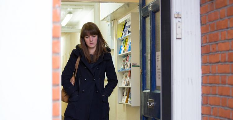 A young girl walking out of a hospital