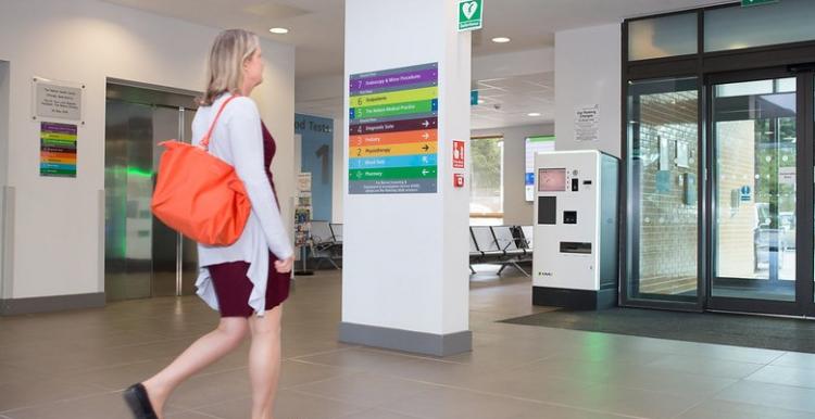 Lady walking out of a hospital