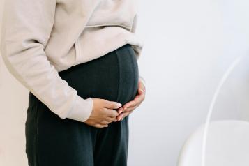 pregnant woman holding her stomach